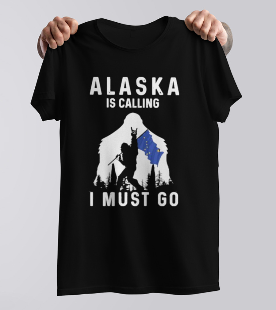 Alaska Is Calling I Must Go Bigfoot Holding Alaska Flag T-Shirt