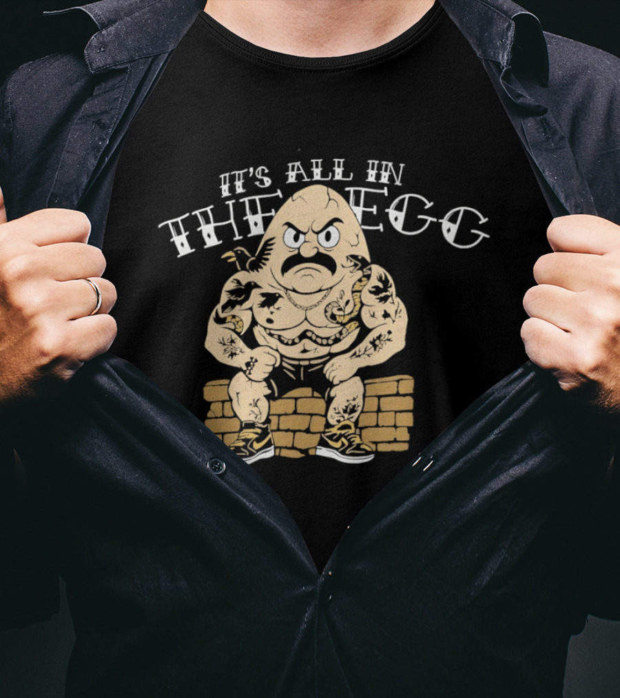 It's All In The Egg Muscular Cartoon Character With Mustache Sitting On Brick Wall T-Shirt