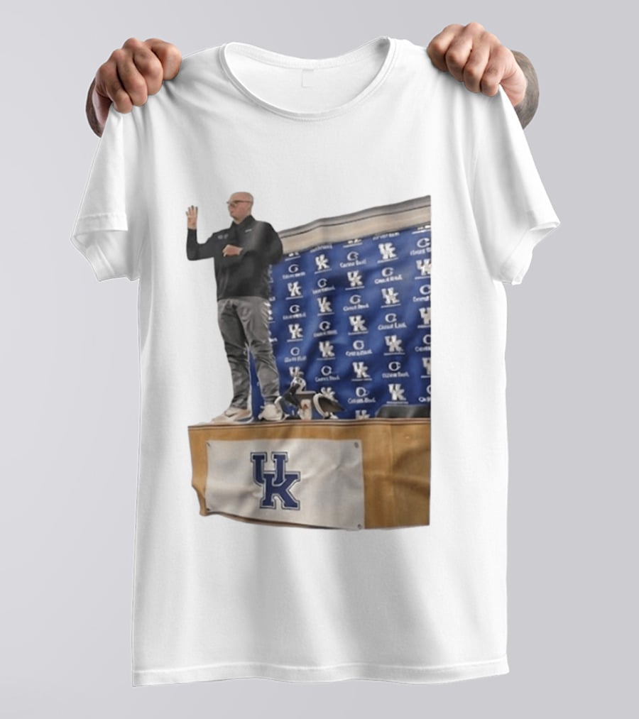 UK Volleyball Coach Craig Skinner Standing On Table With UK Logo And Awards T-Shirt