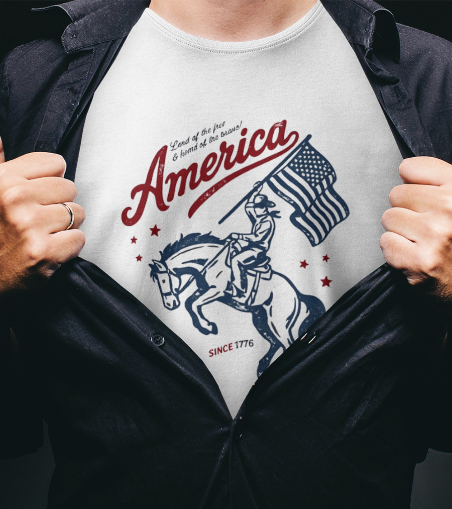 America Land Of The Free Home Of The Brave Since 1776 Cowboy Holding Flag Patriotic T-Shirt