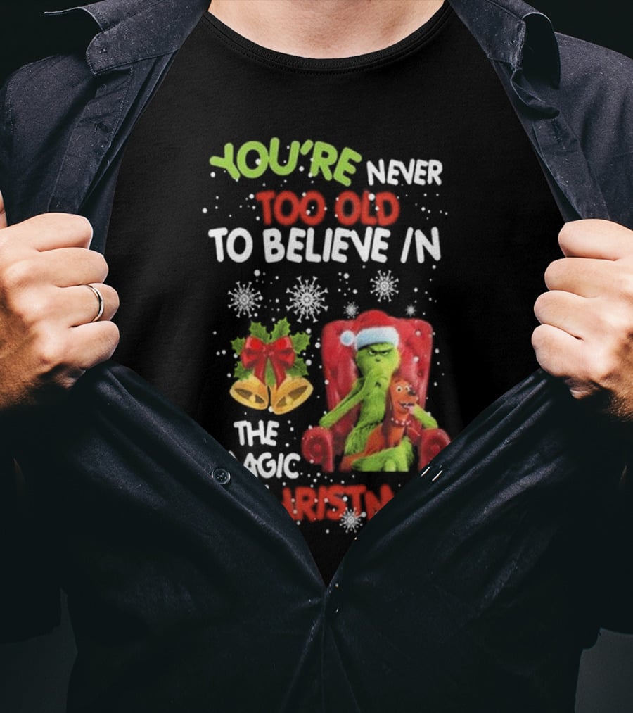 YOU'RE NEVER TOO OLD TO BELIEVE IN THE MAGIC OF CHRISTMAS GRINCH WITH MAX SITTING IN CHAIR SNOWFLAKES HOLIDAY BELLS AND BOW T-Shirt